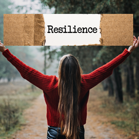 Mental Health nurse - Women in red jumper holding a carboard sign saying resilience