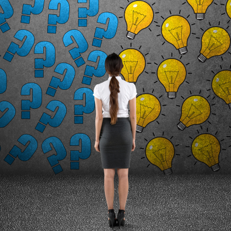 A woman dressed in grey skirt and write blouse wondering whar decision to make.